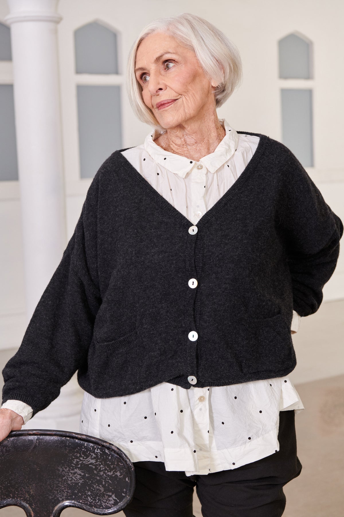 A MegbyDesign model is wearing a white and black spotted classic collared and cuffed button down shirt