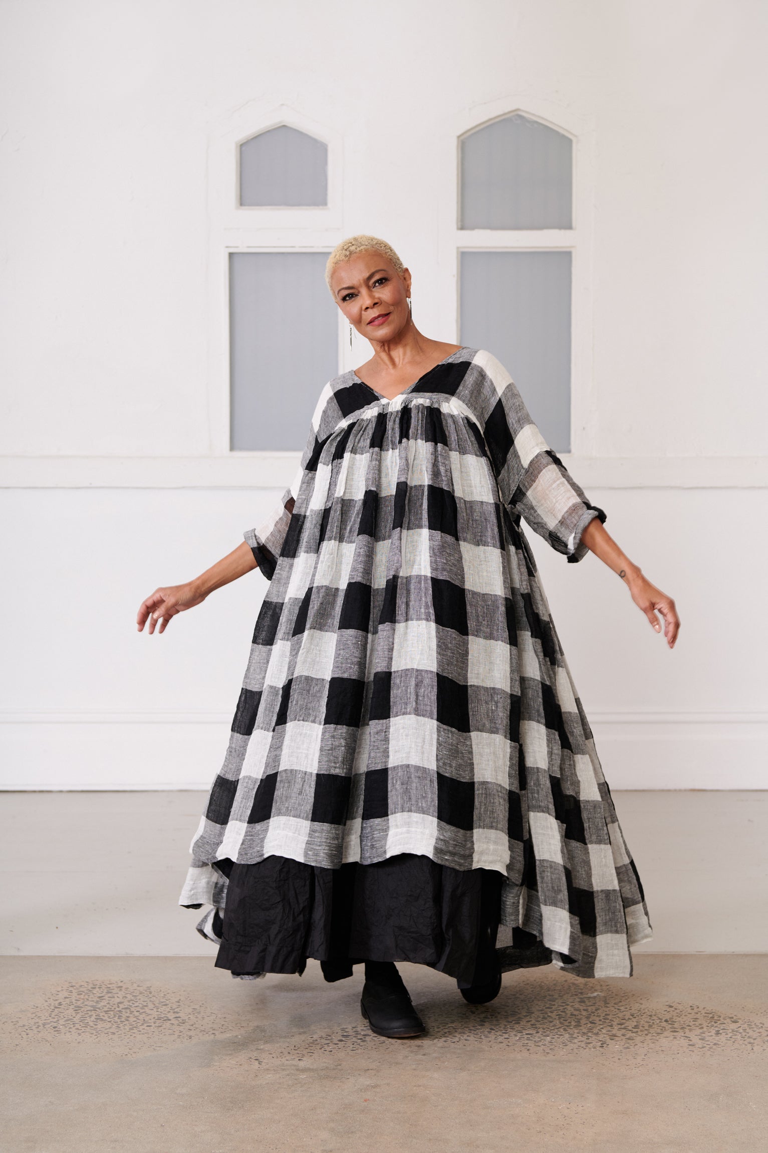 A MegbyDesign model is wearing a black and white gingham soft gauze linen tunic dress