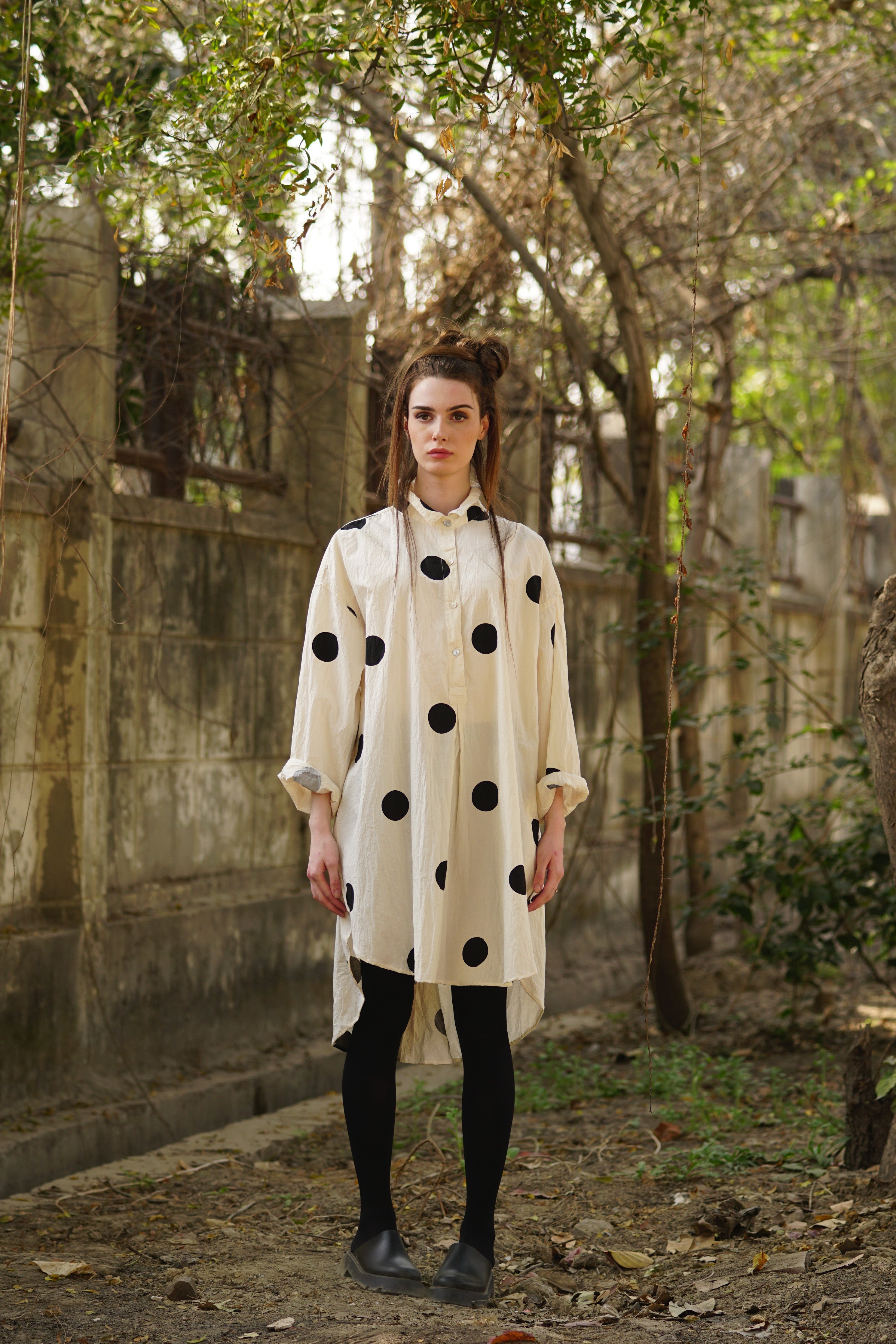 A MegbyDesign model is wearing a classic tuxedo style shirt with black spots made from cotton twill
